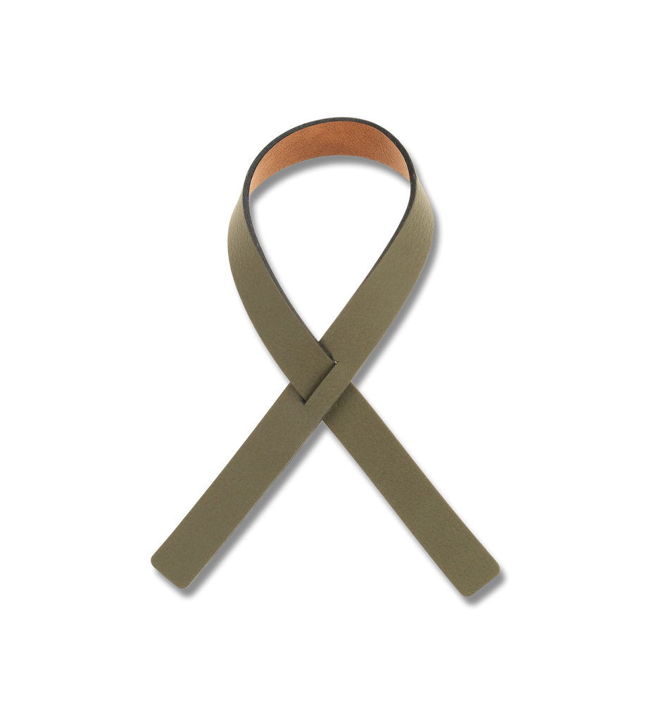 A green ribbon looped around LIND DNA's NAPKIN LOOP (SET OF 4), made from recycled leather, placed on a white background at the dinner table.