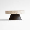 A round coffee table with a black base, showcasing architectural heritage with ORIGIN MADE's COLISEU PEDESTALS.