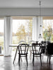 A dining room with a white HAPPY HOMES CREATIVE table and chairs from the COZY brand.