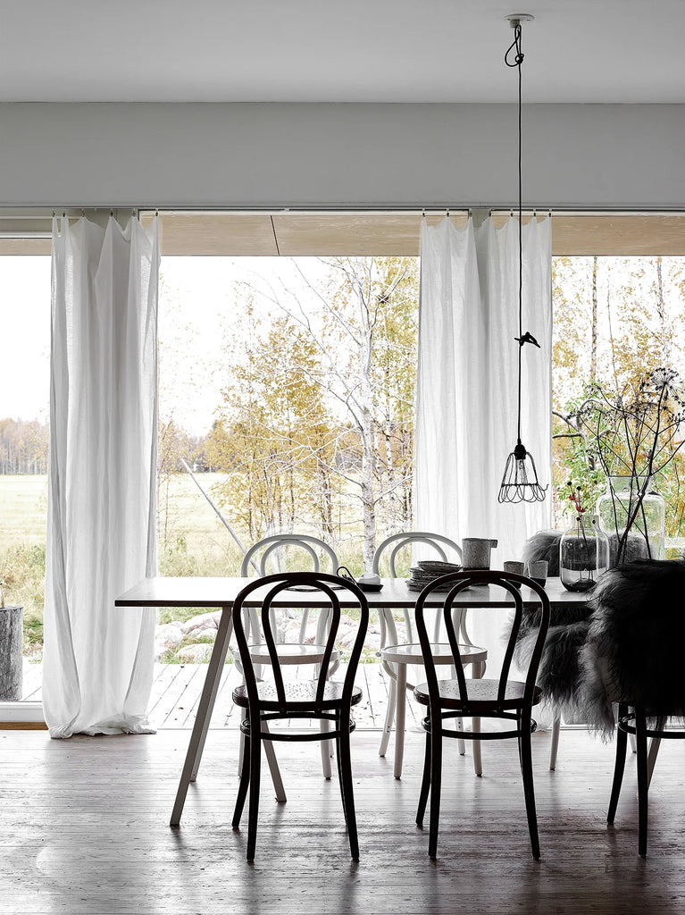 A dining room with a white HAPPY HOMES CREATIVE table and chairs from the COZY brand.
