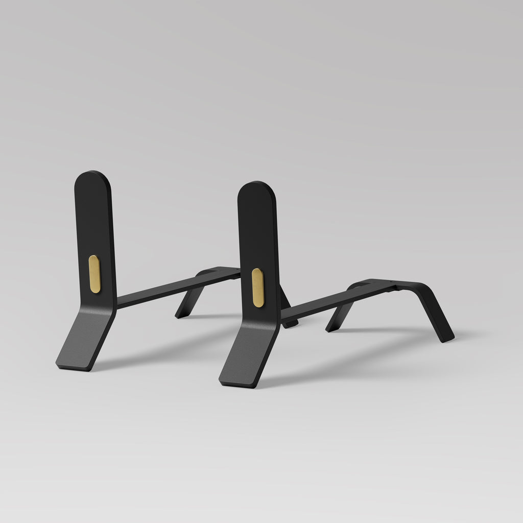 A pair of Eldvarm Cooper Fire Dogs by ELDVARM, in a modern and minimalist design, displayed on a grey background.