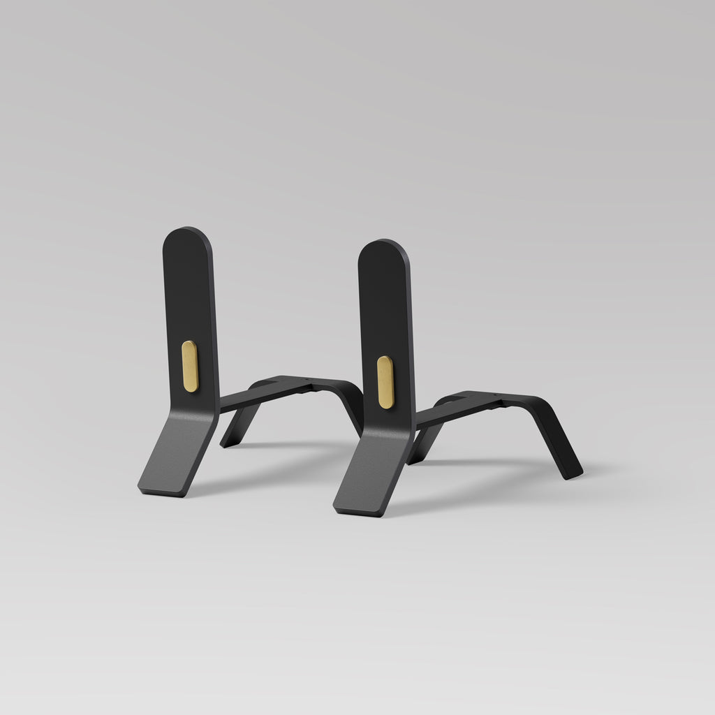 A minimalist design featuring a pair of ELDVARM COOPER FIRE DOGS with brass detail on a grey background.