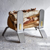 A minimalist design metal log holder with vintage cast ELDVARM COOPER FIRE DOGS.