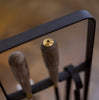 A pair of EMMA FIRE TOOL COMPANION SET utensils in an ELDVARM metal holder.