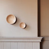 Two Gestalt Haus ADÃO COAT PEGs on the wall of a room (Brand Name: ORIGIN MADE).