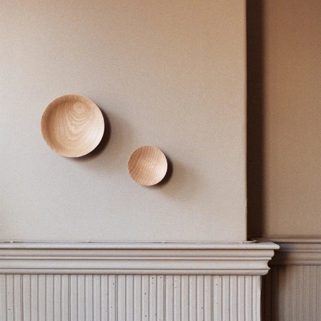 Two Gestalt Haus ADÃO COAT PEGs on the wall of a room (Brand Name: ORIGIN MADE).