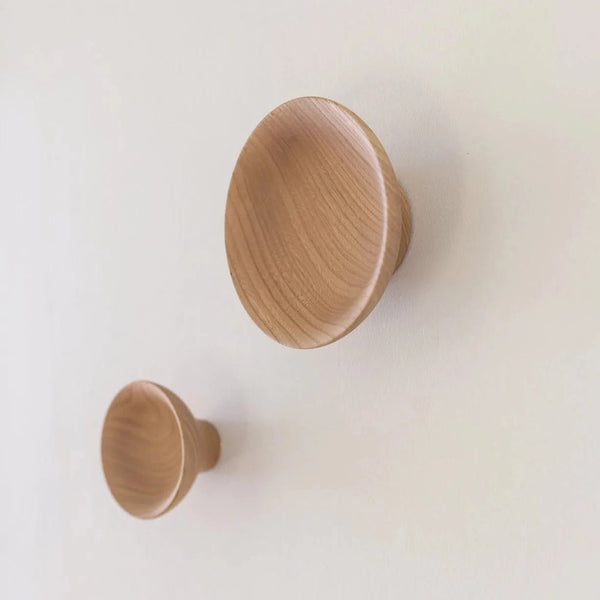 Two Gestalt Haus ADÃO COAT PEGs hanging on the wall.