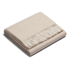 An ALPACA HERRINGBONE THROW with fringes on a white background by SIBAST, showcasing Gestalt style.