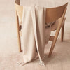 A Gestalt Haus chair with an Alpaca Herringbone Throw by SIBAST.