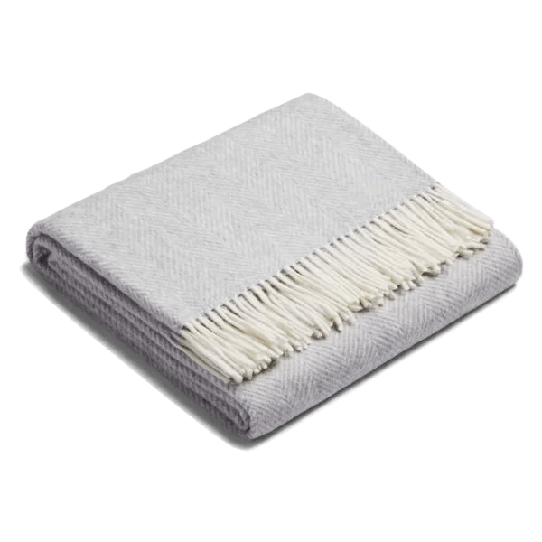A SIBAST ALPACA HERRINGBONE THROW from Gestalt Haus with fringes.