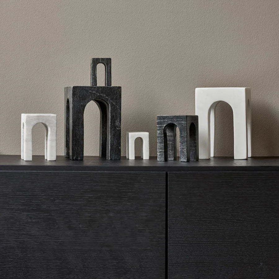 Four ARKIS MARBLE SCULPTURES by GEJST sit on top of a black dresser at Gestalt Haus.