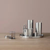 A set of ARNE JACOBSEN SERVING TRAY cups and mugs on a wooden table at Gestalt Haus (STEELTON).
