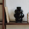 A LOUISE ROE BALLOON VASE 04 elegantly adorns a shelf.