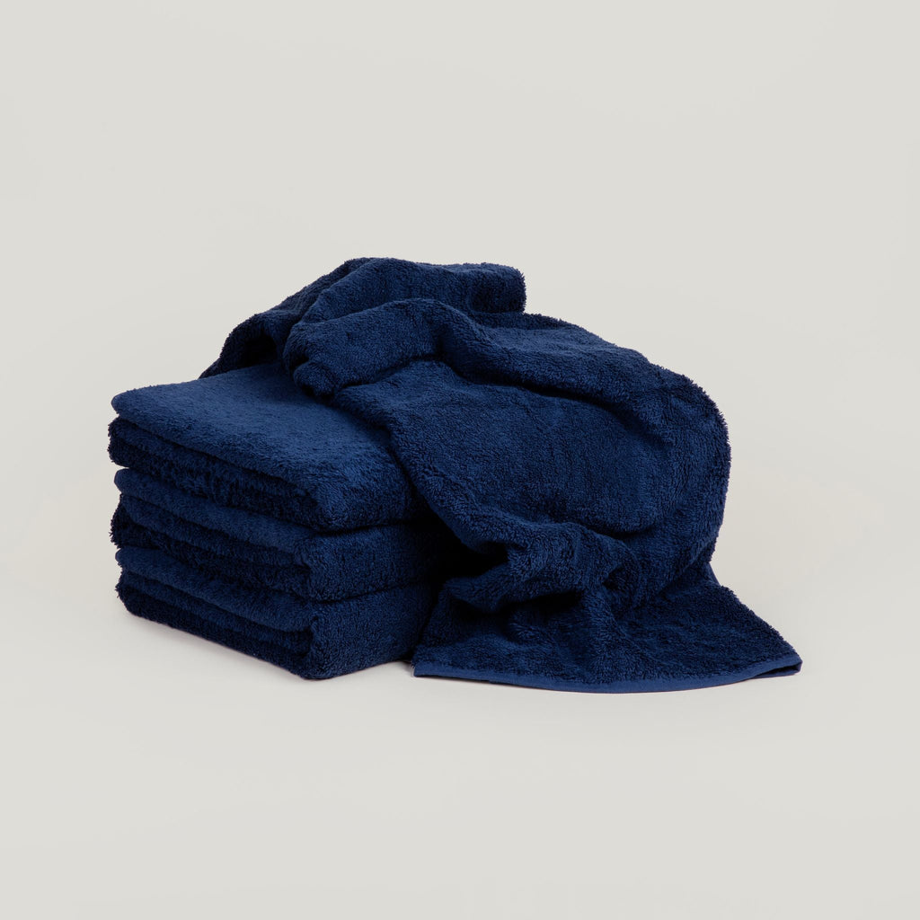 A stack of Gestalt Haus towels on a white background.