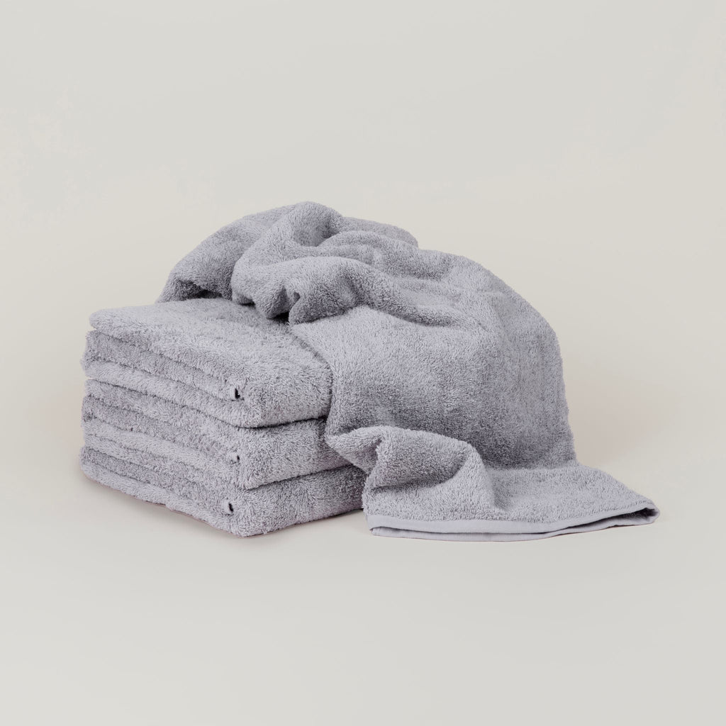 Four GESTALT HAUS BATH SHEETS stacked.
