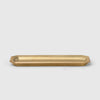 A brass stationery tray on a white background with FUTAGAMI design.