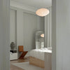 A bedroom with a LOUISE ROE CERAMIC BALLOON VASE 04 GRANDE bed and mirror designed in a Gestalt Haus style.