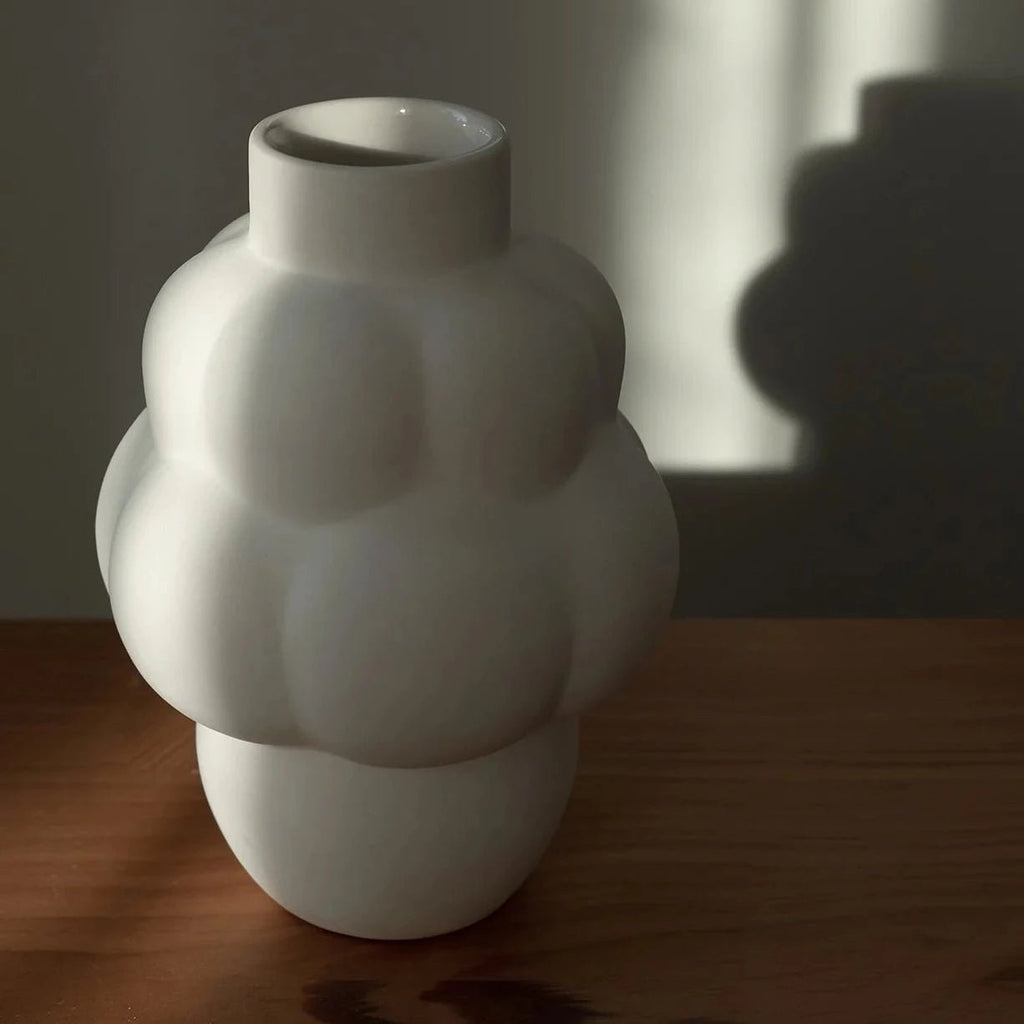 A LOUISE ROE CERAMIC BALLOON VASE 04 PETITE adorns a wooden table at Gestalt Haus.