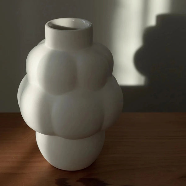 A LOUISE ROE CERAMIC BALLOON VASE 04 PETITE adorns a wooden table at Gestalt Haus.