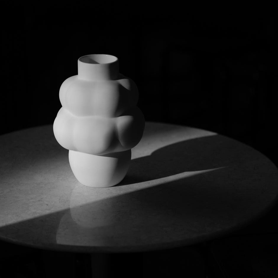 A LOUISE ROE CERAMIC BALLOON VASE 04 PETITE enhances the ambiance of a dark room at Gestalt Haus.
