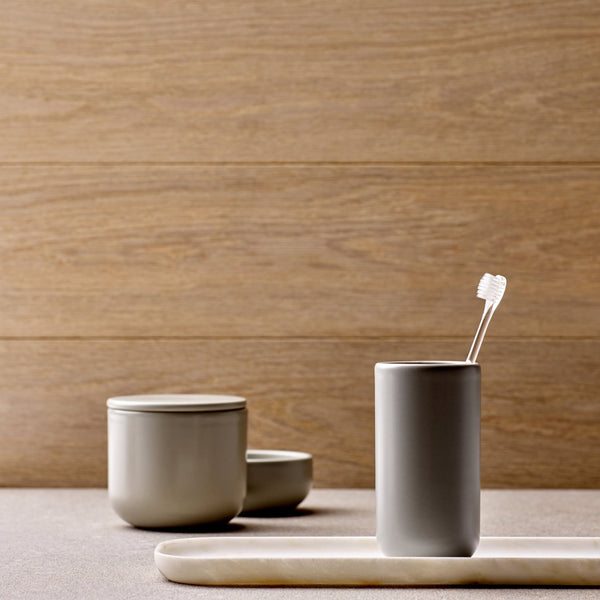 A Ceramic Bathroom Set with Oak Tray featuring a cup and spoon.