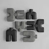 A group of COBRA DOUBLE SCULPTURES by 101 COPENHAGEN arranged on a white surface in the Gestalt Haus.