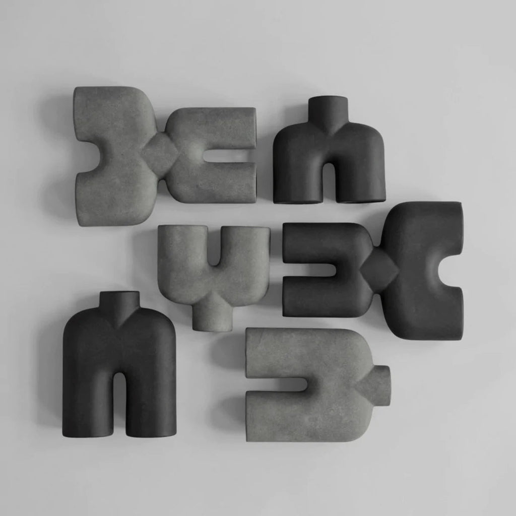 A group of COBRA DOUBLE SCULPTURES by 101 COPENHAGEN arranged on a white surface in the Gestalt Haus.