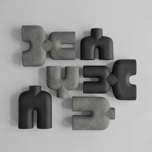 A group of COBRA DOUBLE SCULPTURES by 101 COPENHAGEN arranged on a white surface in the Gestalt Haus.