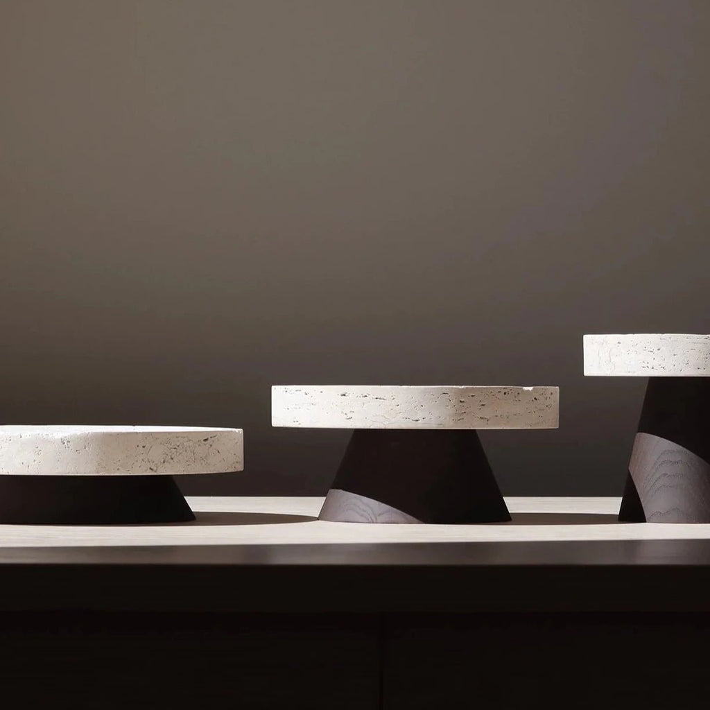 Three COLISEU PEDESTALS by ORIGIN MADE on top of a table.
