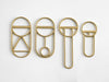 A group of FS OBJECTS CREST BOTTLE OPENERS on a white surface.