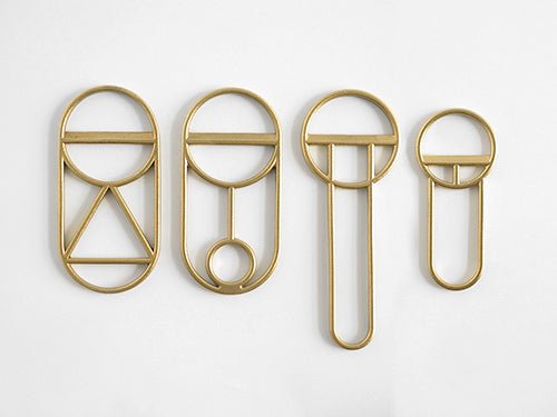 A group of FS OBJECTS CREST BOTTLE OPENERS on a white surface.