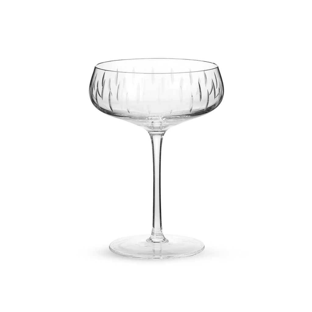 A Louise Roe Crystal Champagne Coupe on a green background at the Gestalt Haus.