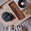 A tray displaying a COOEE DREAMER SCULPTURE and a candle at Gestalt Haus.