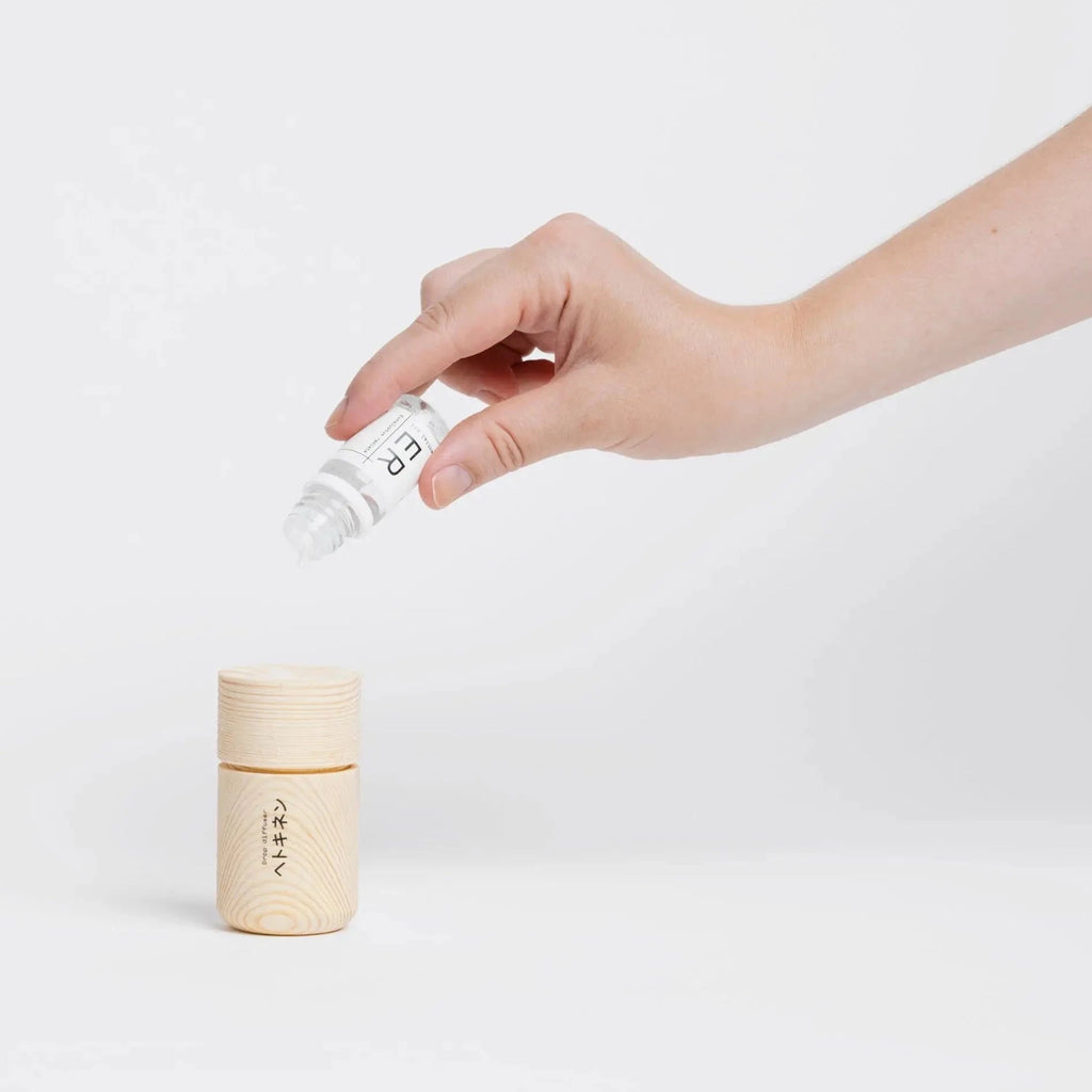 A hand reaching into a Gestalt Haus drop oil diffuser.