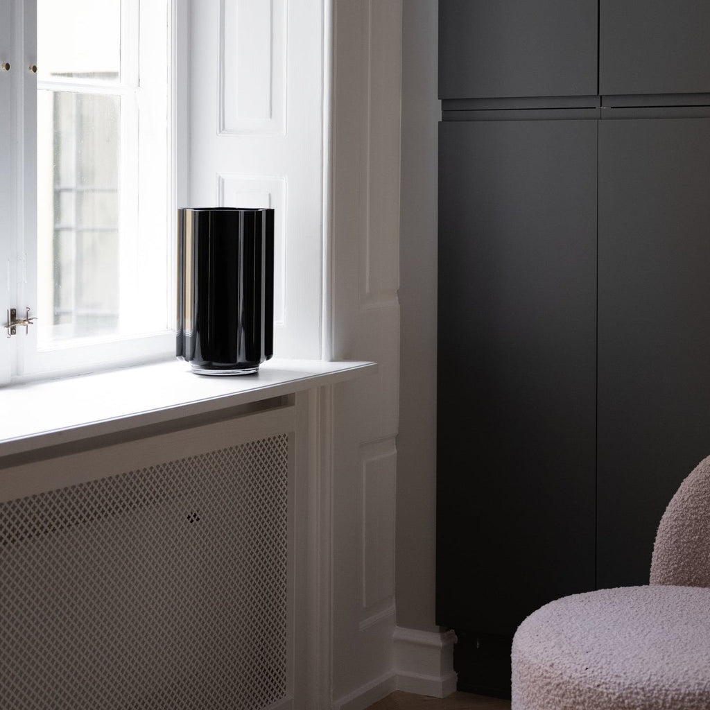 A FUNKI VASE ASYMMETRIC by LOUISE ROE adorns the window of a Gestalt Haus room.