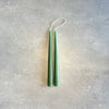 Two DANICA DESIGNS HAND-DIPPED TAPER CANDLES adorned in a Gestalt Haus, hanging on a wall.