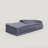 A stack of Gestalt Haus hand towels on a white background.