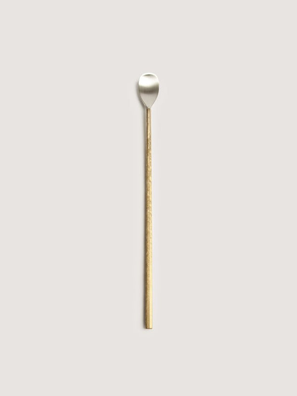 An IHADA MUDDLER SPOON with a gold handle on a white background, designed by FUTAGAMI, embodies the essence of Gestalt Haus.
