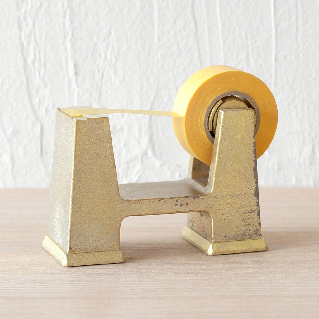 An IHADA tape dispenser from FUTAGAMI on a wooden table at Gestalt Haus.