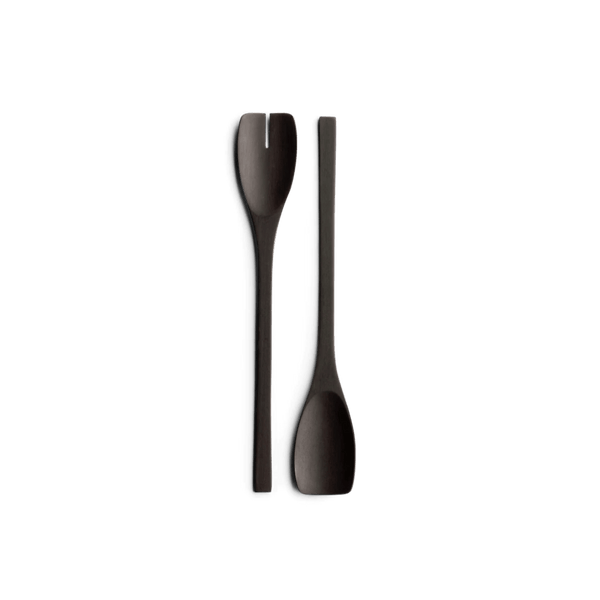 Two JOHN PAWSON SALAD SERVERS by WHEN OBJECTS WORK on a black background, showcasing the elegant design of Gestalt Haus.
