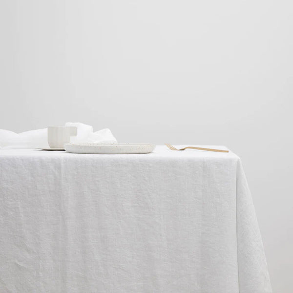 A CULTIVER linen tablecloth adorned with a spoon atop it at Gestalt Haus.