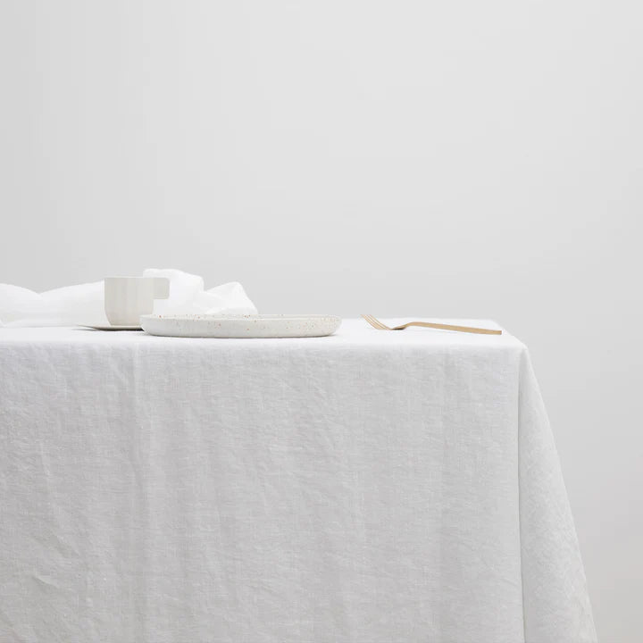 A CULTIVER linen tablecloth adorned with a spoon atop it at Gestalt Haus.