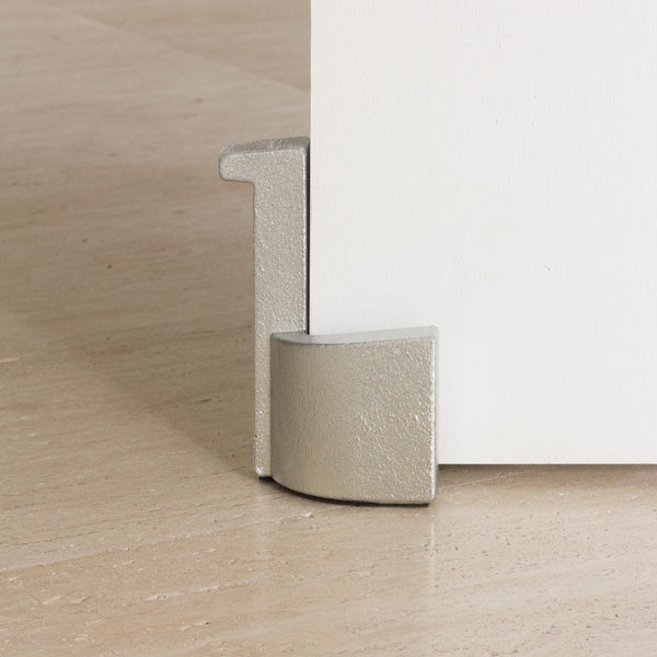 A Laker Studio white door with a metal handle on it.