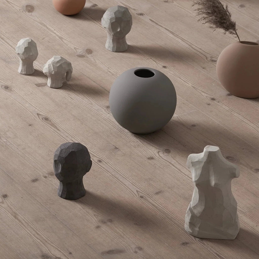 A group of OLUFEMI HEAD SCULPTURE vases on a wooden floor at Gestalt Haus, brand: COOEE.