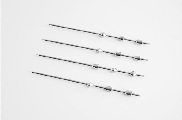 Four SPAR COCKTAIL PICKS on a white surface.