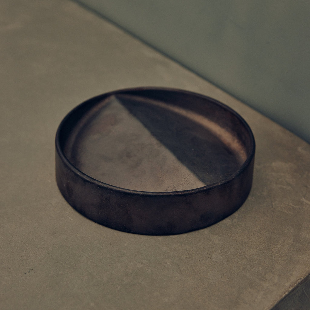 A VIDE POCHE ROND by STUDIO HENRY WILSON sitting on top of a concrete floor at Gestalt Haus.